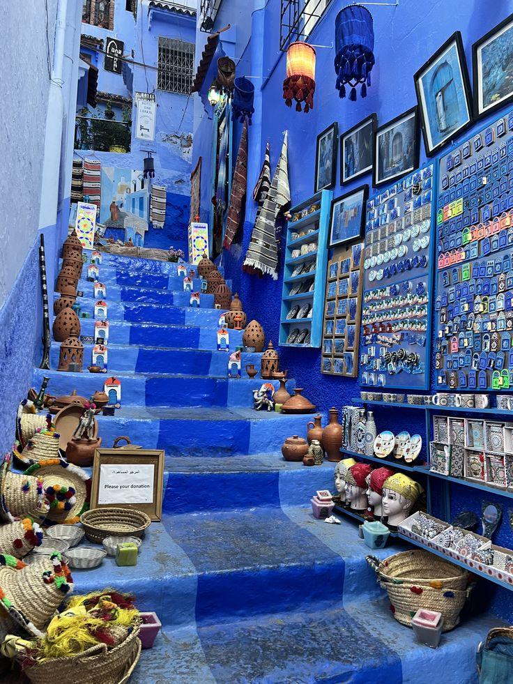 Blue painted walls, steps and potted plants in the Chefchaouen medina