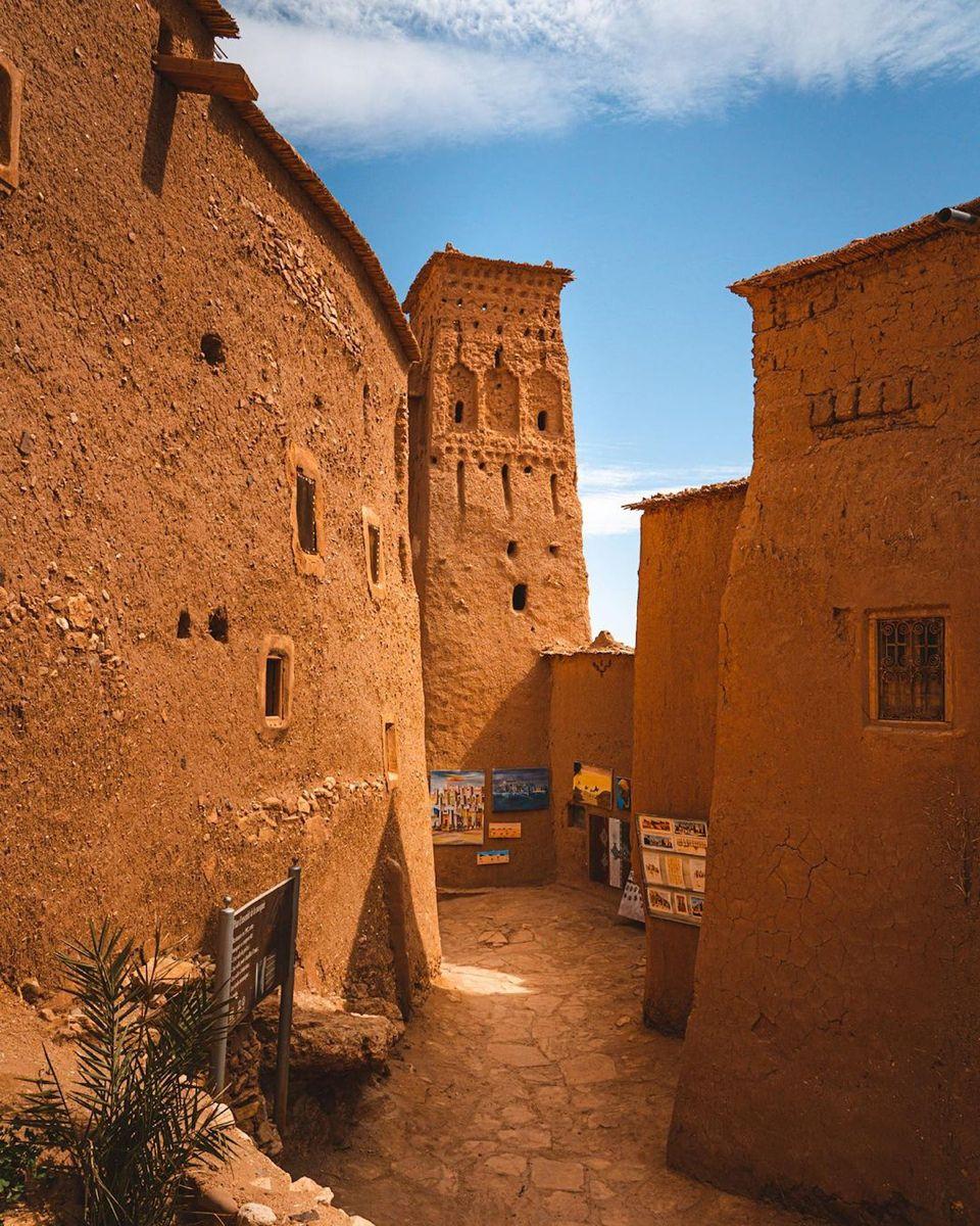 Sunlit passage between the earthen walls of Ait Ben Haddou