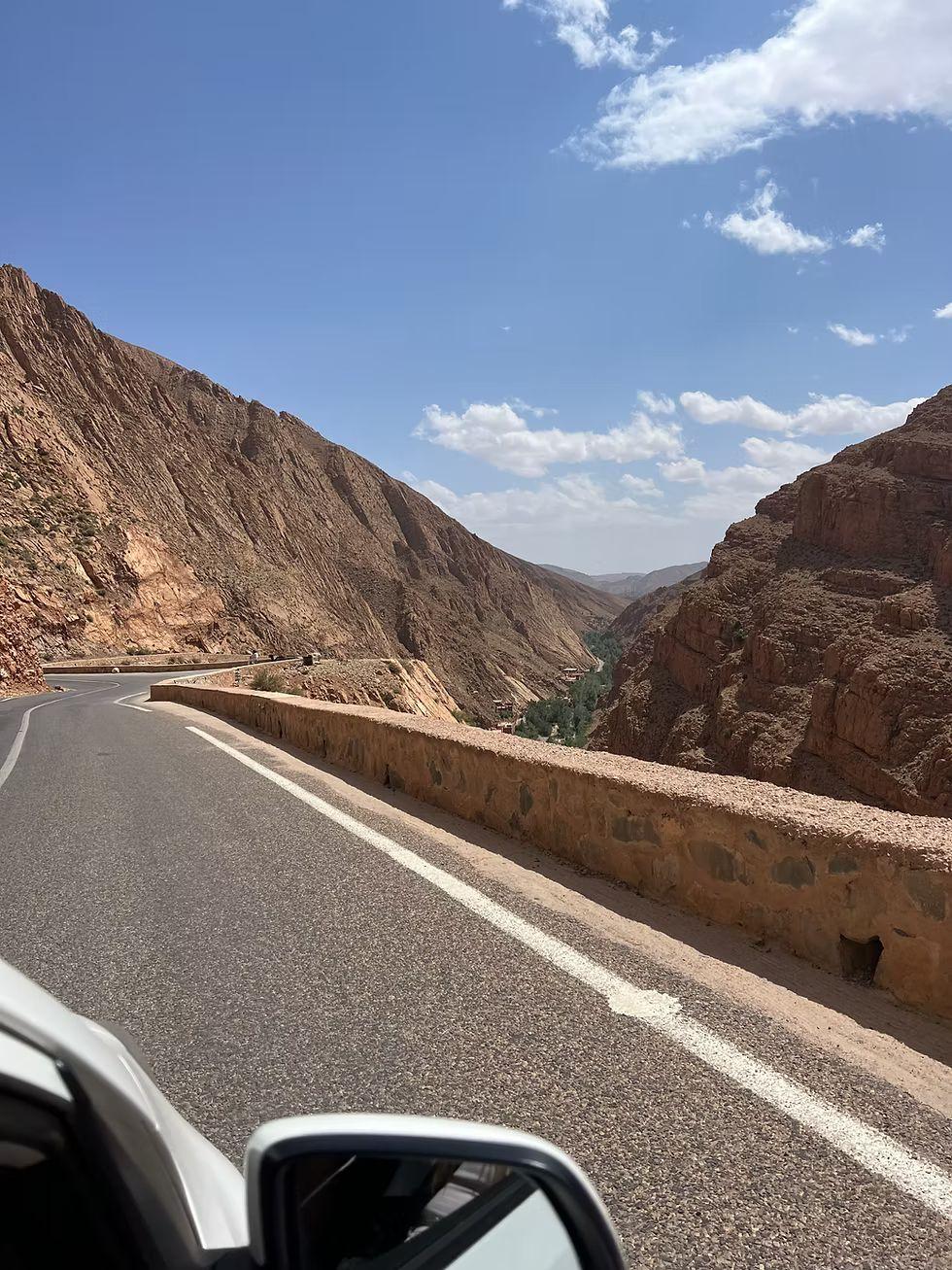 Palm groves of the Ziz Valley framed by a stone arch near Errachidia