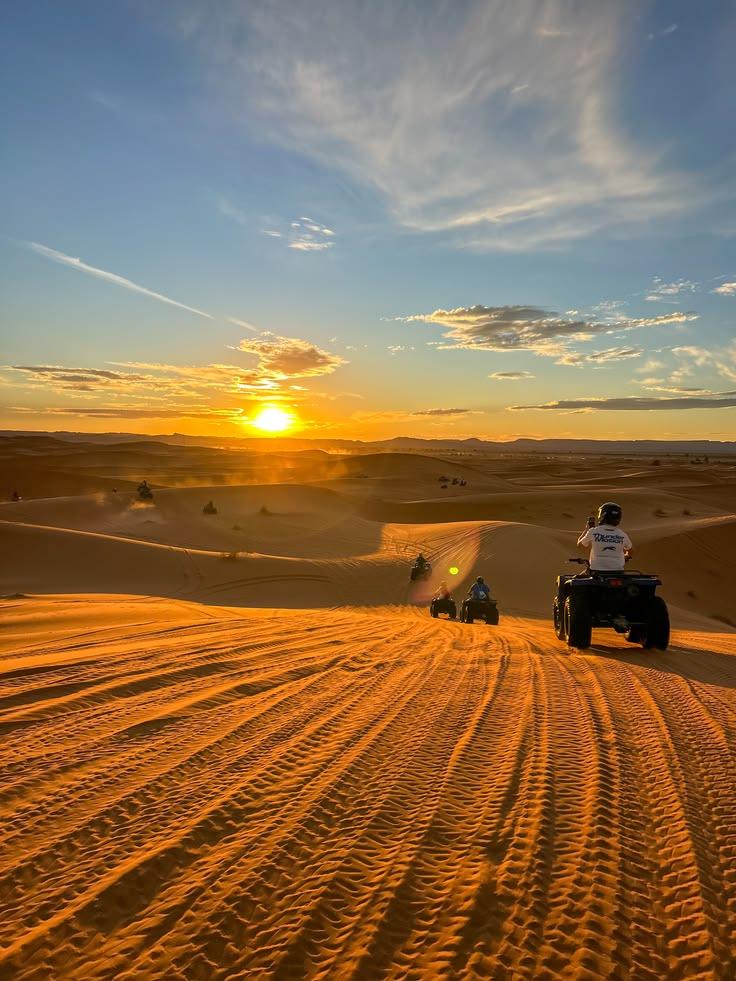 Desert vehicles overlooking the Merzouga dunes